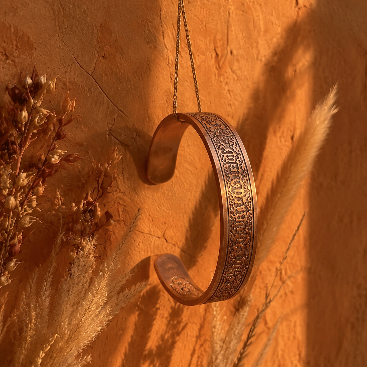 Cuivre Sibylle wide copper cuff bracelet against a warm terracotta background