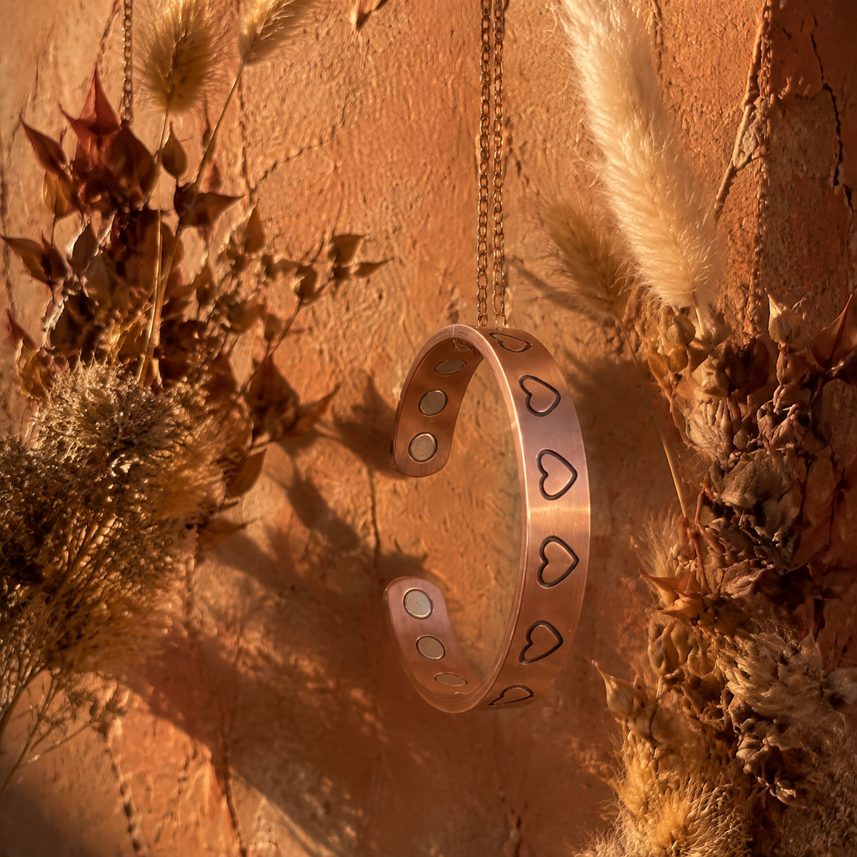 Cuivre Valentine heart copper cuff bracelet against a warm terracotta background