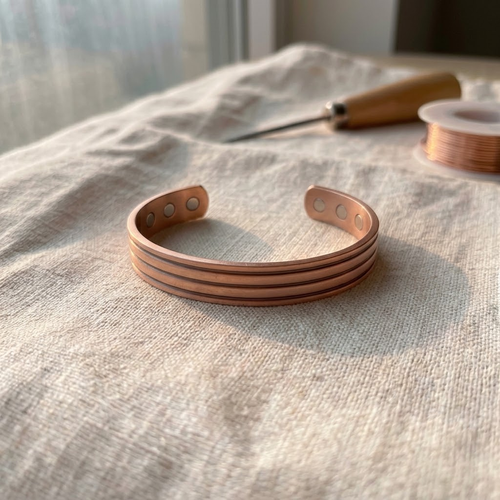 Cuivre Sixtine striped copper cuff bracelet on linen