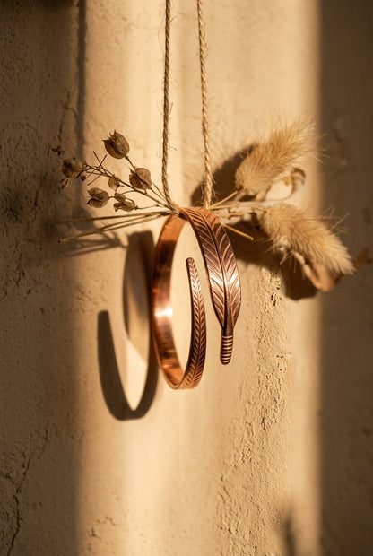 Cuivre Sidonie copper bracelet hanging from twine in golden hour light