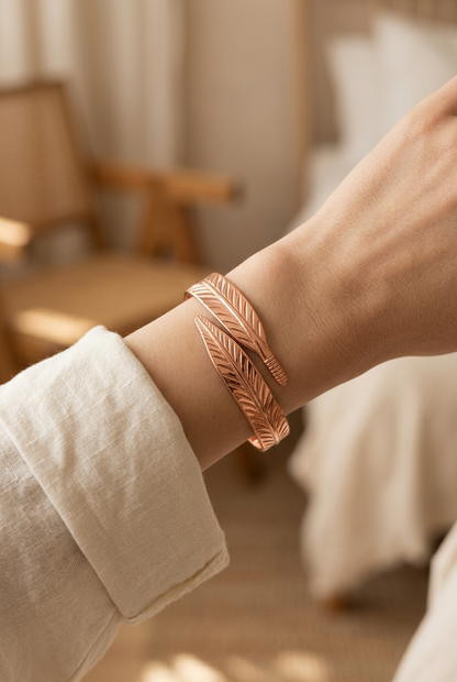 Woman wearing Cuivre Sidonie copper bracelet on wrist with cream linen sleeve